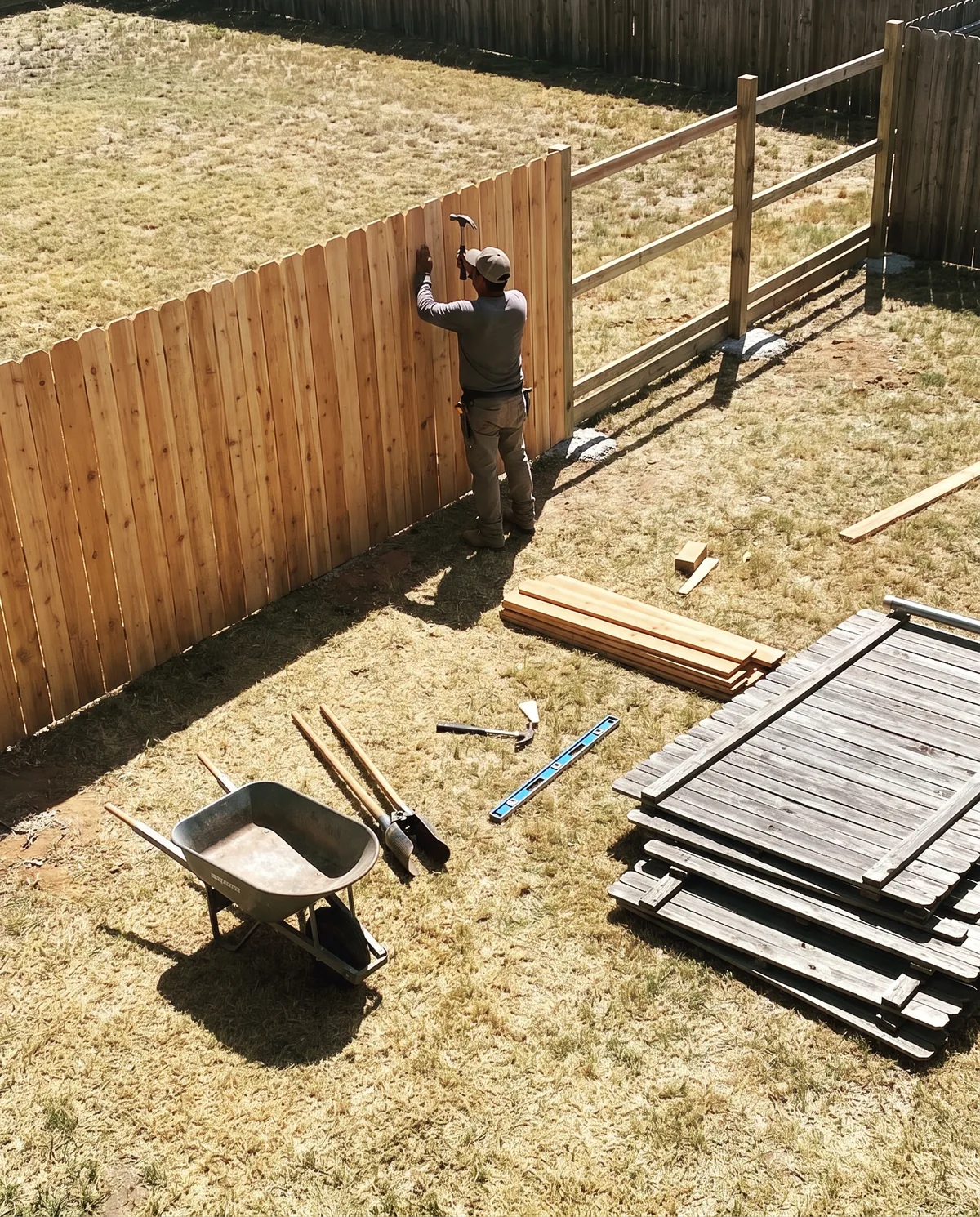 Wood privacy fence installation with new boards and rails