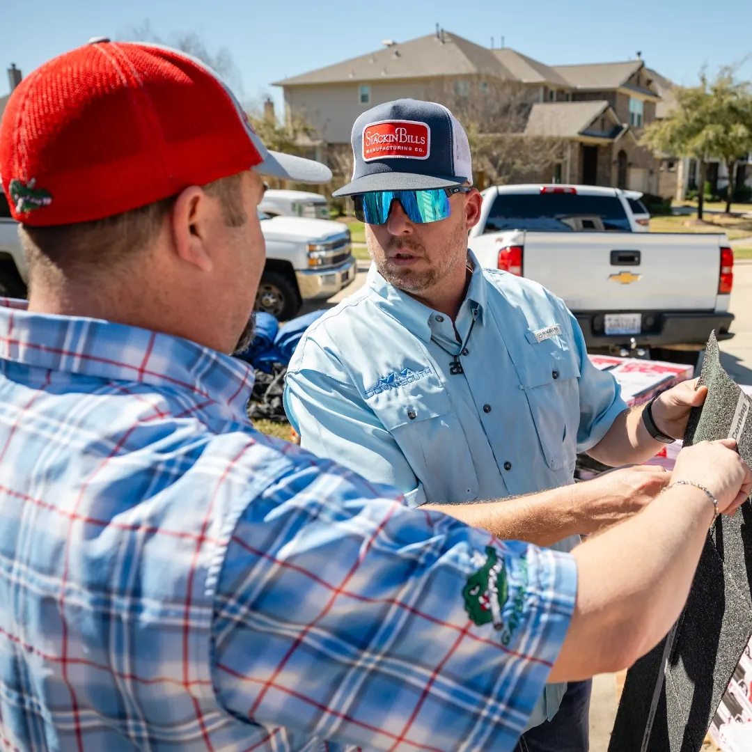 Down South team members comparing roofing shingle samples